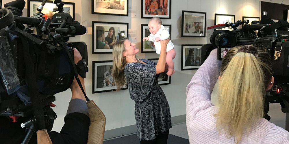 Mother and baby with News crew